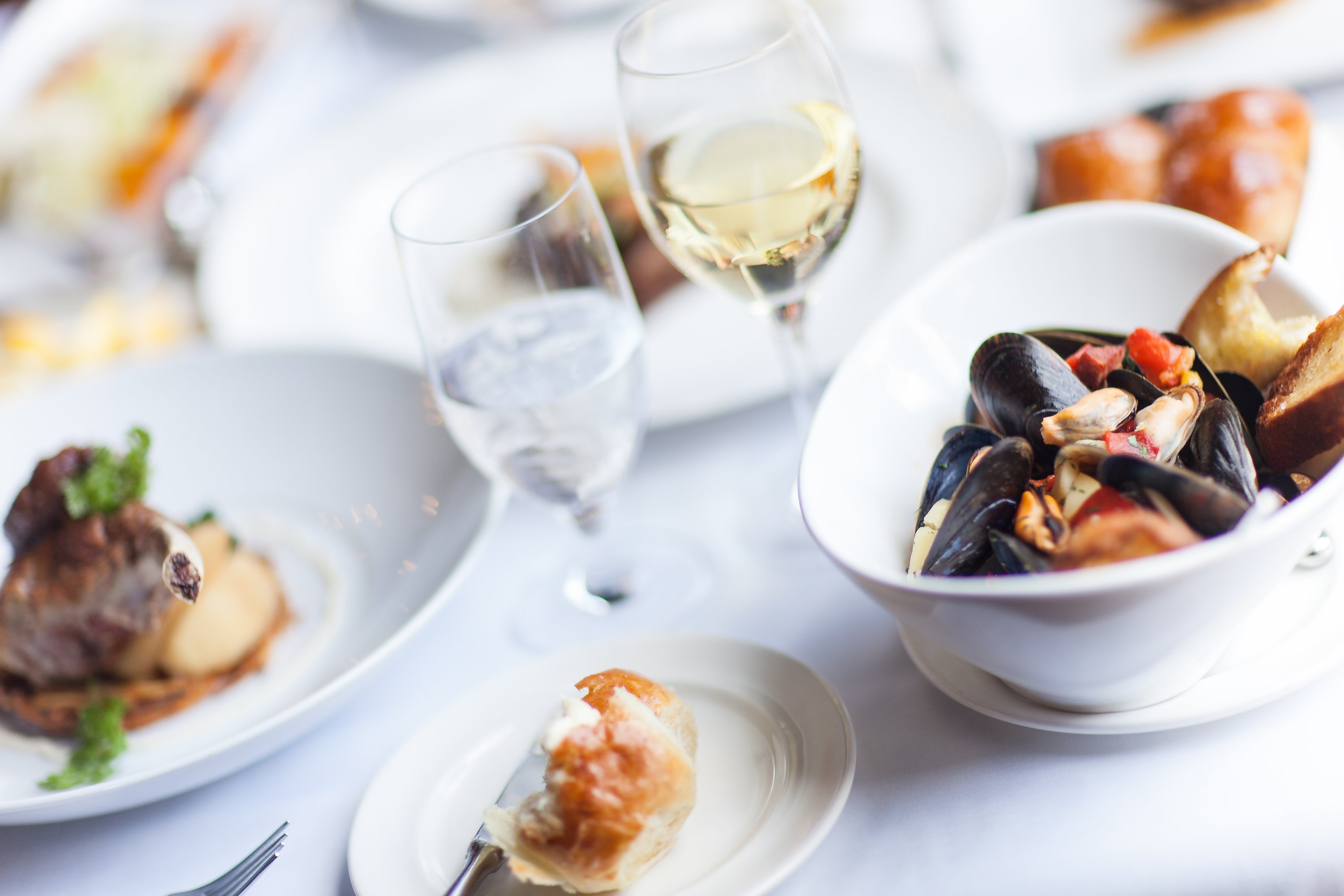 Various prepared dishes on white tablecloth